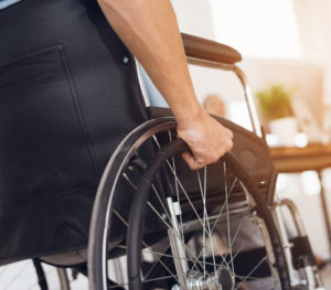 Injured man on wheel chair Going to meet Dallas Personal Injury Lawyer